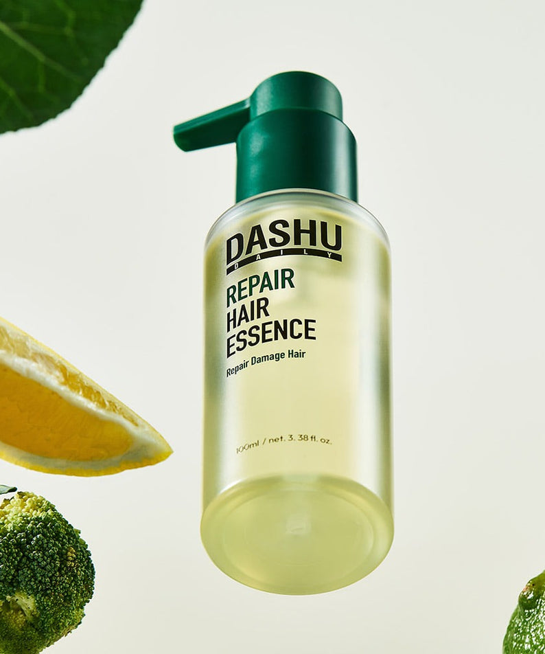 DASHU Daily Repair Hair Essence 100ml, flacon vert avec marque DASHU sur fond blanc, feuilles et gouttes, visuel beauté.