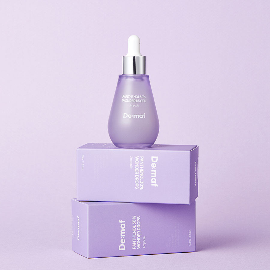DE:MAF Panthenol 30% Wonder Drops 55ml de De:maf, flacon violet sur boîte, fond lilas, gouttes panthénol
