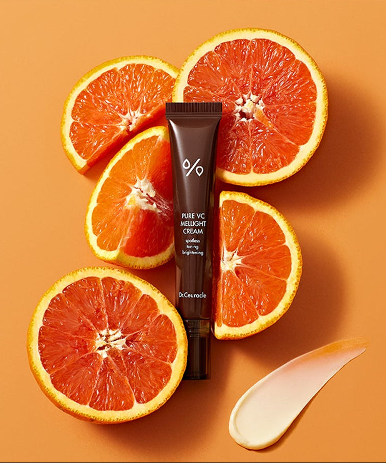 DR.CEURACLE Pure VC Melite Cream 20ml, tube crème sur fond orange avec tranches d’agrumes et crème.