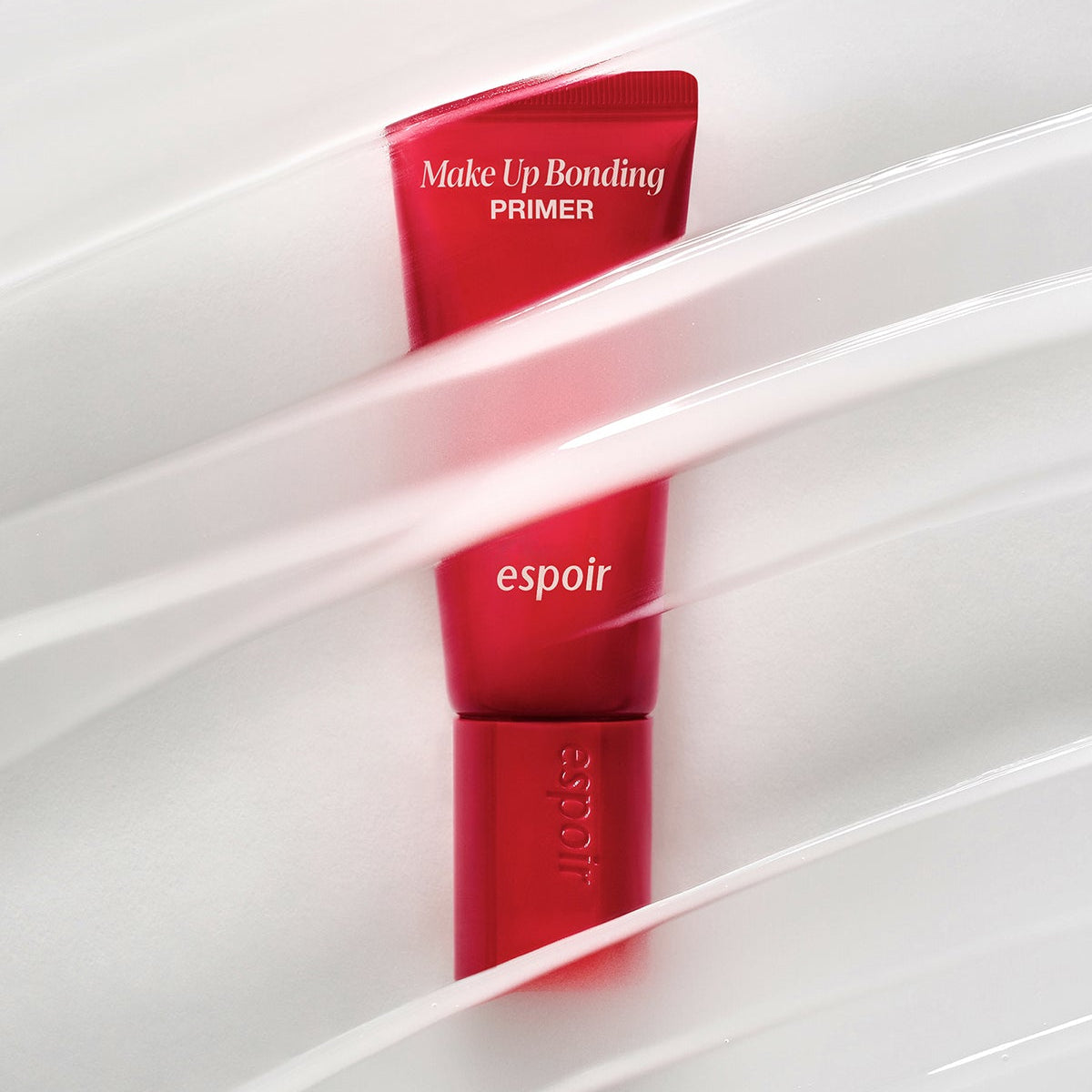 ESPOIR Make Up Bonding Primer de la marque espoir, tube rouge dans un étui blanc, contexte maquillage