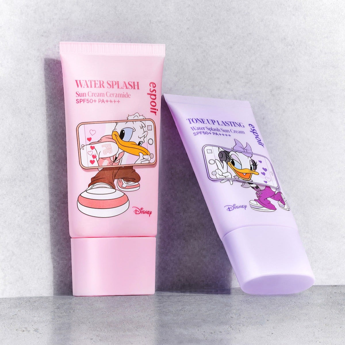 ESPOIR Water Splash Sunscreen Tone Up Lasting [Disney Edition] crème SPF avec design Disney, flacons sur fond clair