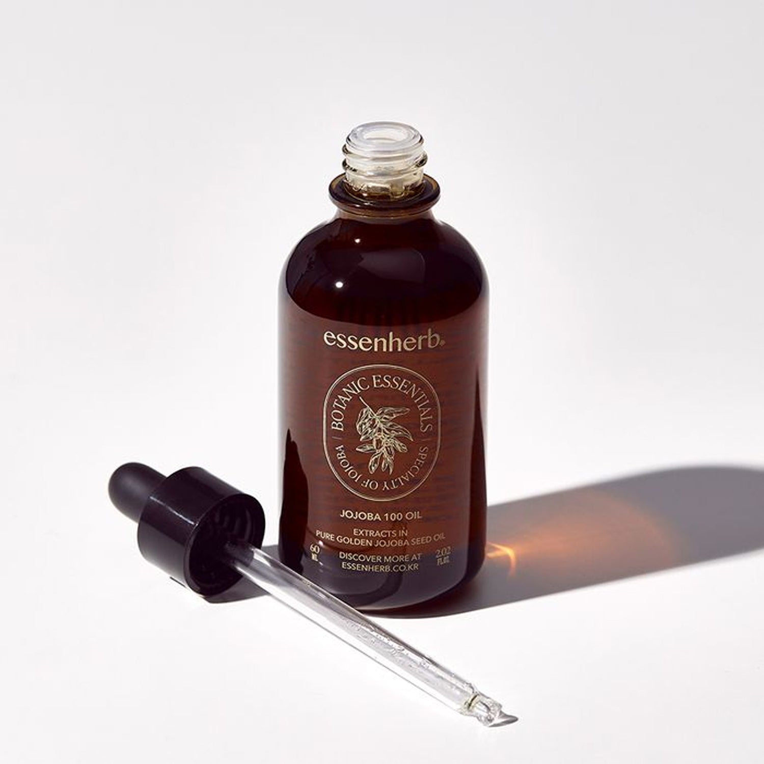 ESSENHERB Vegan Jojoba 100% Oil Unrefined Cold-Pressed 60ml : flacon brun et pipette sur fond clair, huile pour le visage