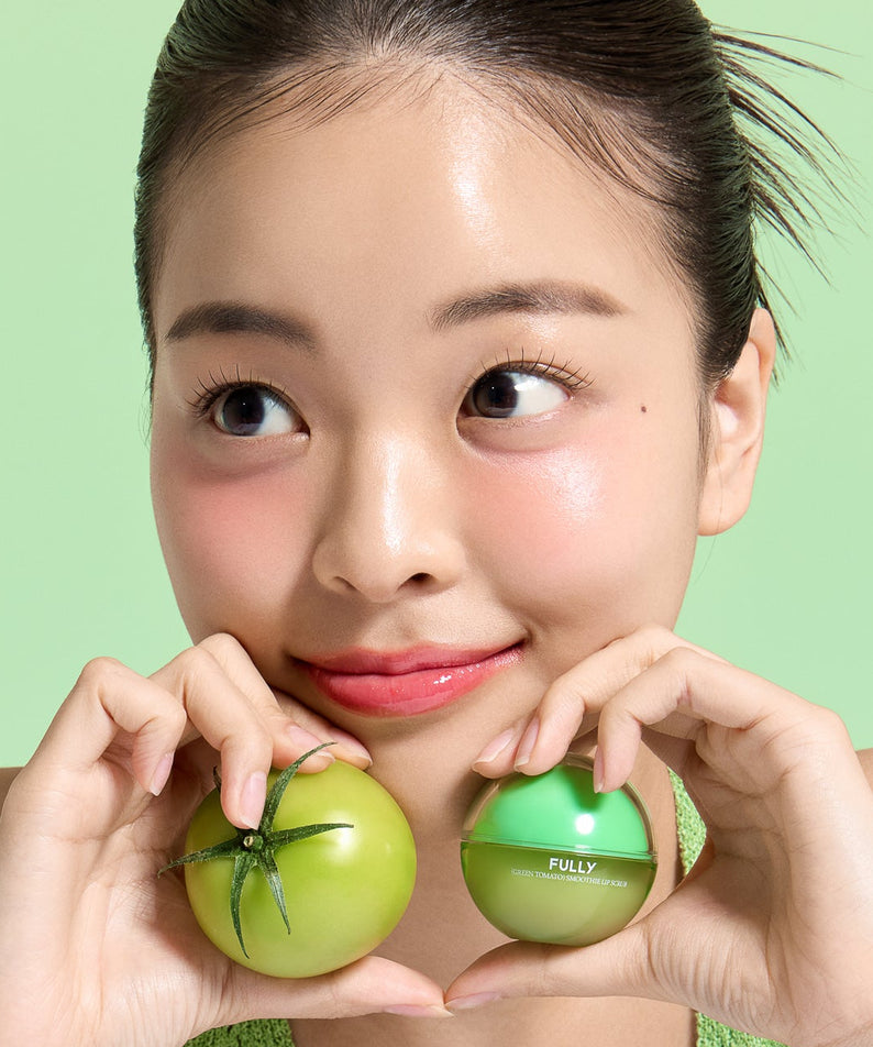 Décris l'image en français : FULLY Green Tomato Smoothie Lip Scrub 12g de la marque FULLY, pots verts sur fond vert.