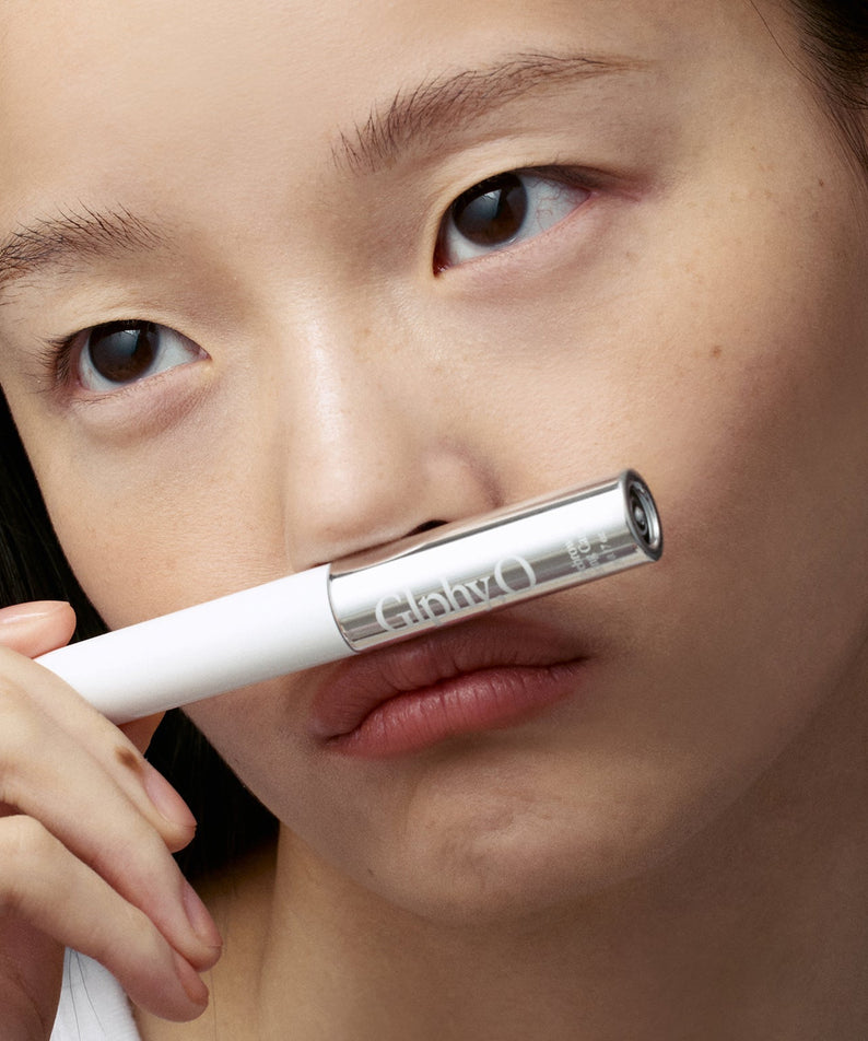 GLPHYO Eyebrow Fixing Cara 5g : femme applique le mascara sur ses sourcils, tube GLPHYO en gros plan.
