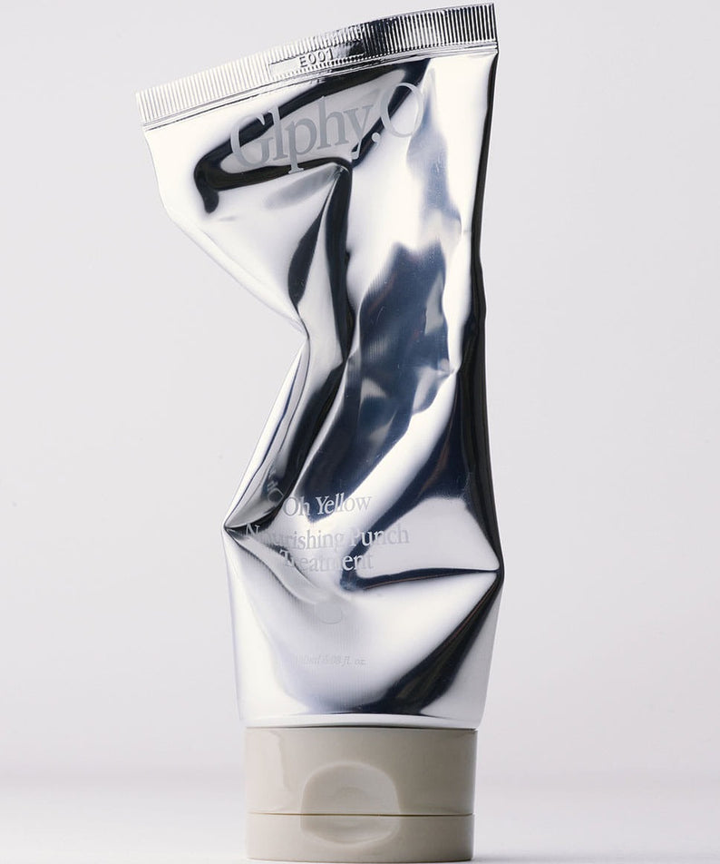 GLPHYO Oh Yellow Nourishing Punch Treatment 180ml, tube cosmétique argenté sur fond clair, marque GLPHYO en gros plan.