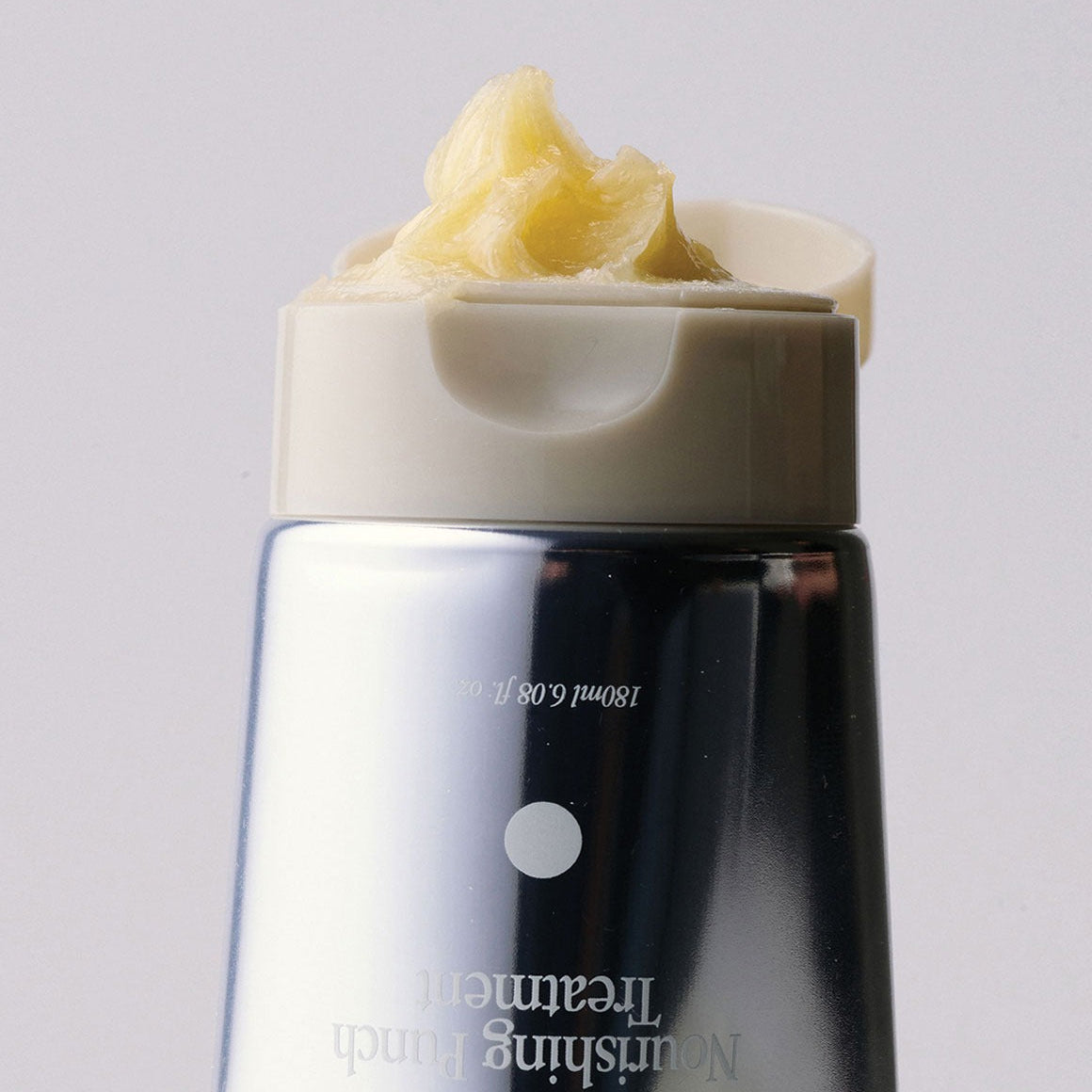 GLPHYO Oh Yellow Nourishing Punch Treatment 180ml : flacon noir et jaune, crème sur le produit, sur fond clair.