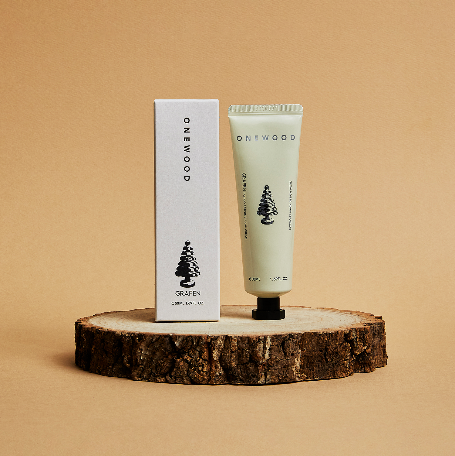 Décris l'image en français: GRAFEN Tattoo Perfume™ One Wood Hand Cream 50ml sur un support en bois, marque GRAFEN.