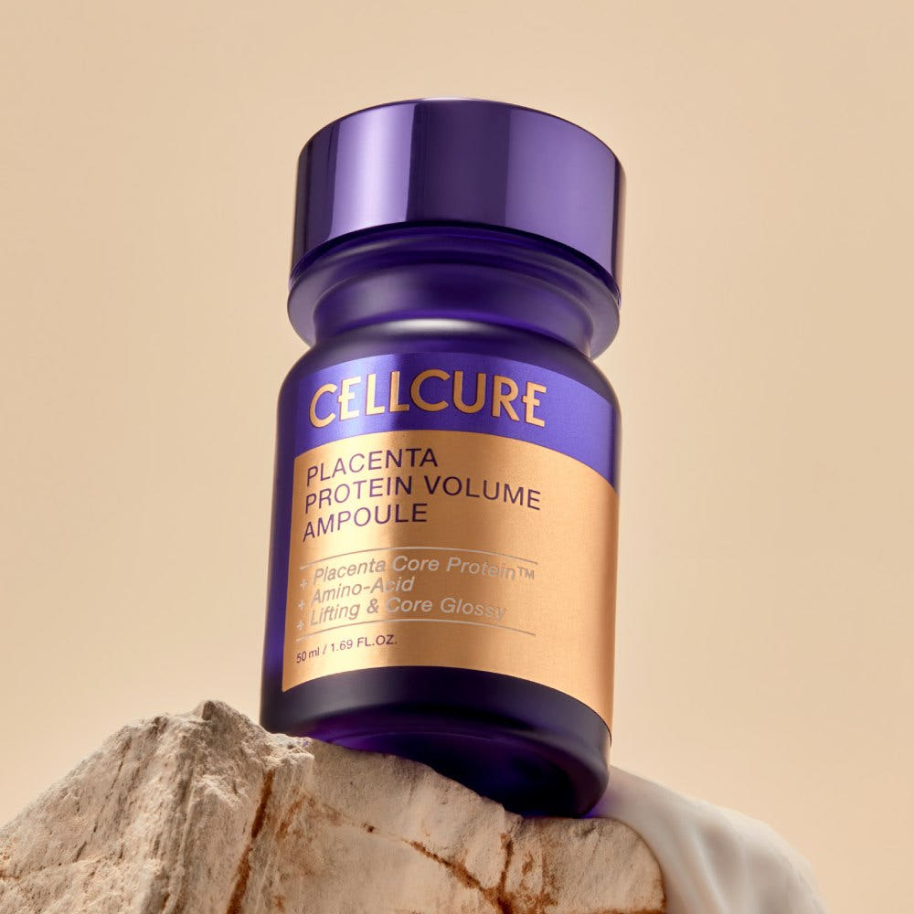 HANSKIN Placenta Protein Volume Ampoule 50ml de la marque HANSKIN, flacon violet sur fond beige, contexte beauté skincare.