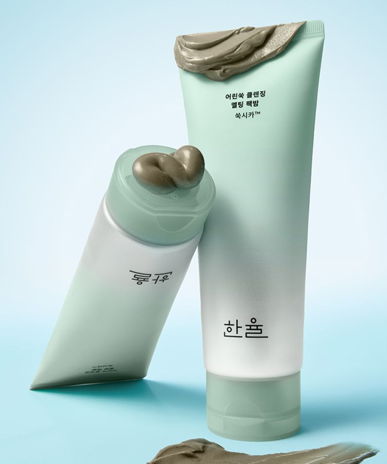 HANYUL Young Artemisia Cleansing Pack Balm 100g de la marque HANYUL, tube vert et texture argileuse sur fond bleu clair