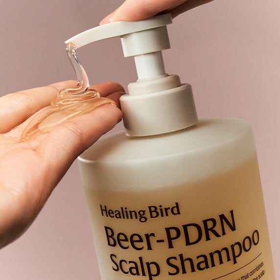 HEALING BIRD Beer PDRN Anti-Hair Loss Shampoo 1000ml : main verse du shampooing, flacon beige, gros plan, salle de bain