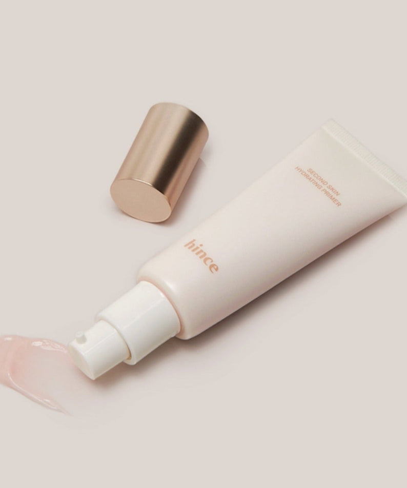 HINCE Second Skin Hydrating Primer en tube, avec bouchon doré, hydratant pour une peau éclatante.