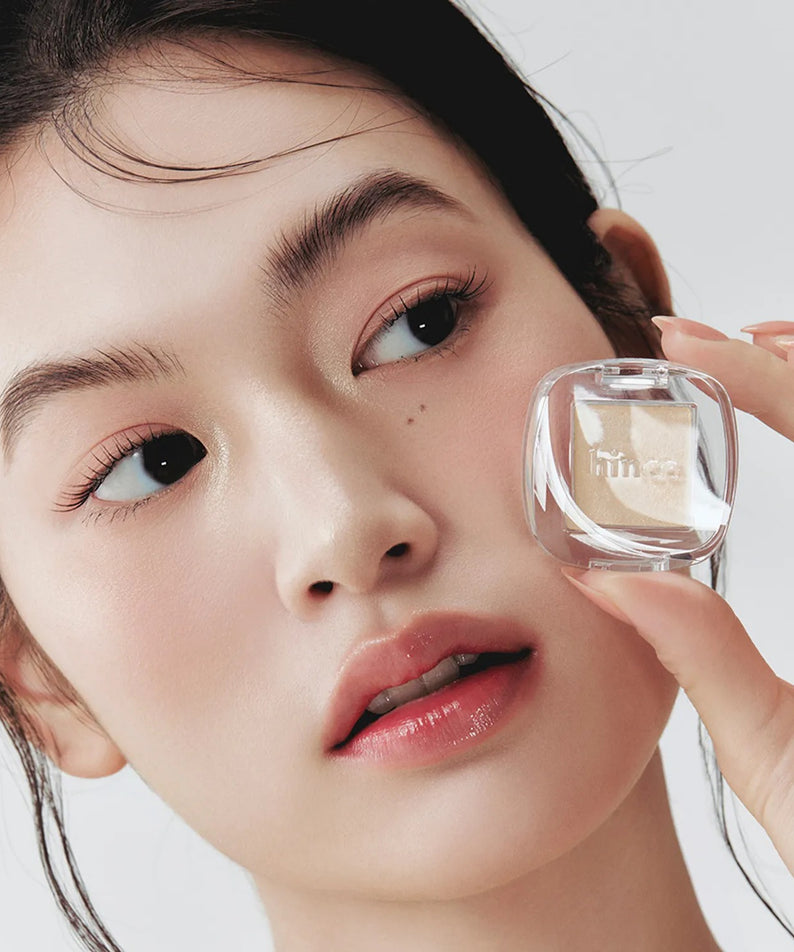 HINCE Single Eyeshadow : maquillage des yeux sur fond blanc, packaging transparent tenu par une femme, marque HINCE