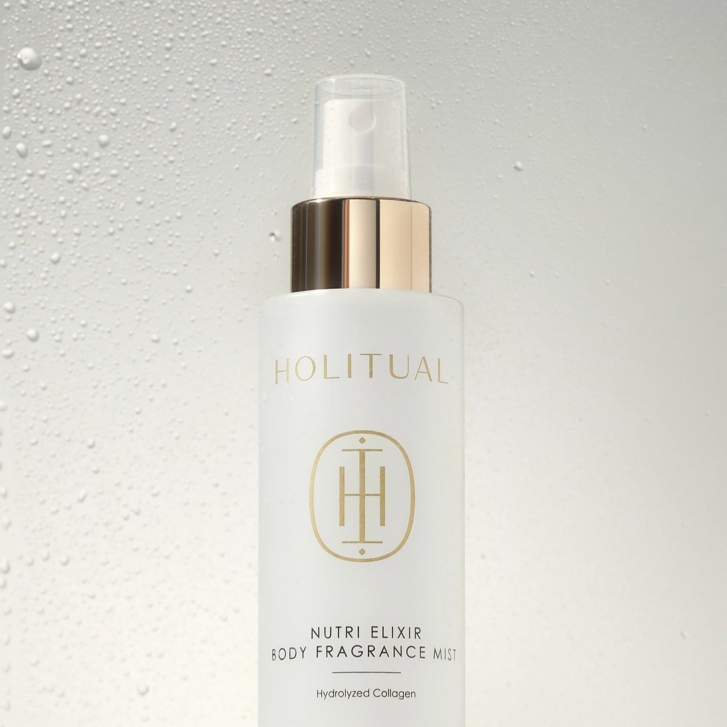 HOLITUAL Nutri Elixir Body Fragrance Mist 100ml de la marque HOLITUAL, flacon sur fond clair avec gouttelettes d’eau