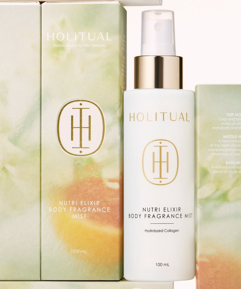 HOLITUAL Nutri Elixir Body Fragrance Mist 100ml, brume parfumée flacon et boîte, sur fond crème avec visuel floral