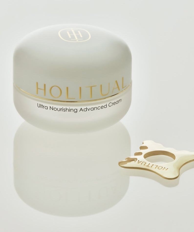 Crème HOLITUAL Ultra Nourishing Advanced Cream avec accessoire doré, crème hydratante avancée pour la peau en pot blanc.