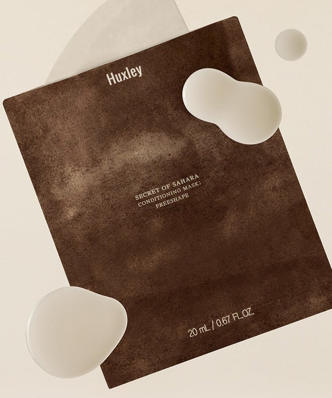 HUXLEY Conditioning Mask Freshape 20ml de Huxley, masque visage sur fond clair, packaging brun et formes cœur blanches.