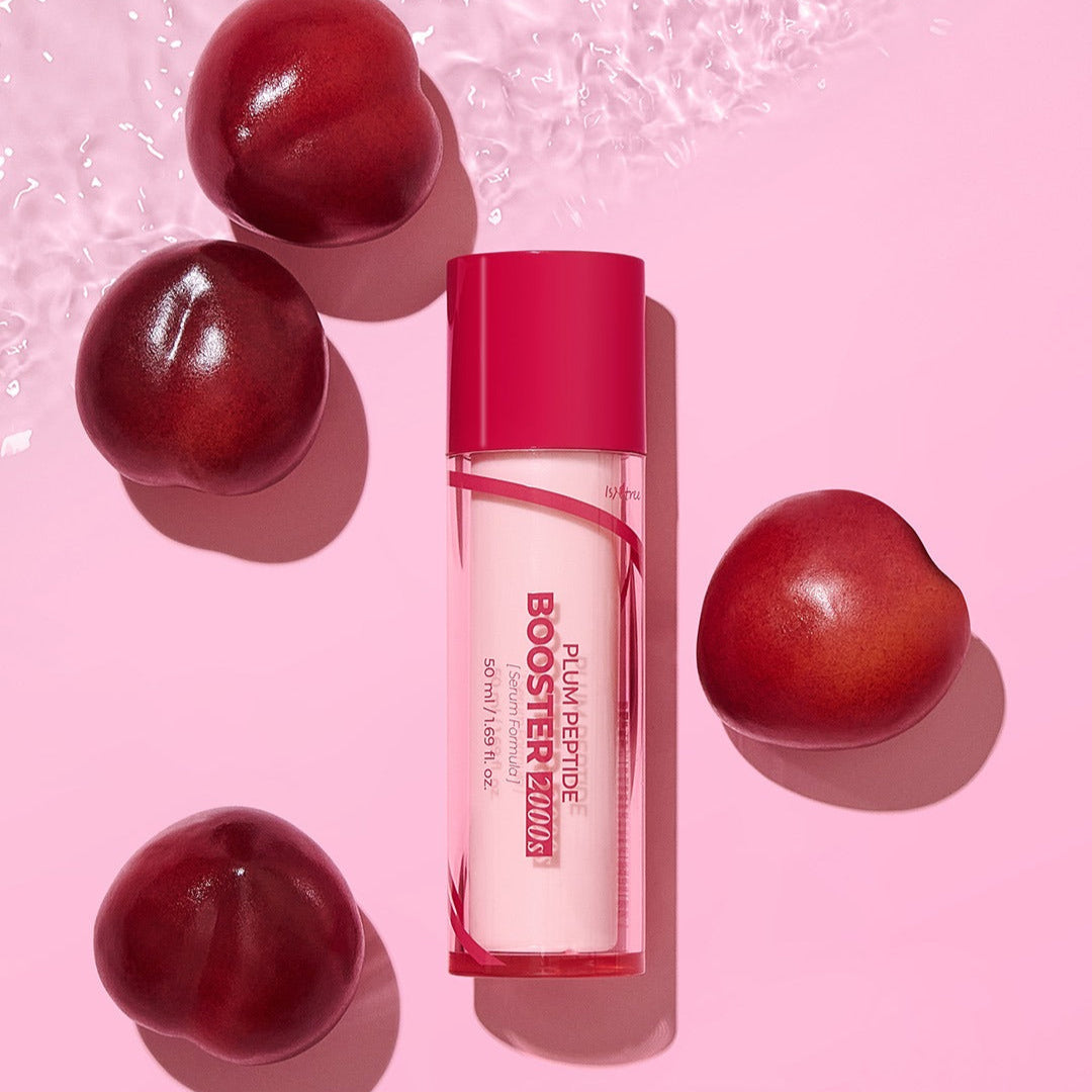 ISNTREE  Plum Peptide Booster 2000s 50ml : flacon rose sur fond rose, avec prunes rouges et lumière studio.