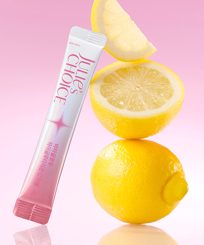 JULIE'S CHOICE Vita Glow High Glutathione C Double 23 Pieces sur fond rose avec citrons et packaging visible.
