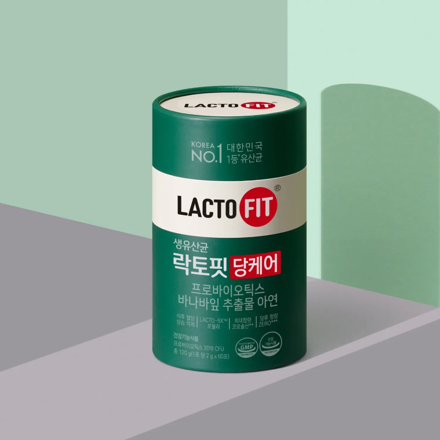 Décris l'image en français : LACTO-FIT Blood Sugar Care 60 Sticks, tube vert LACTO FIT sur fond moderne.