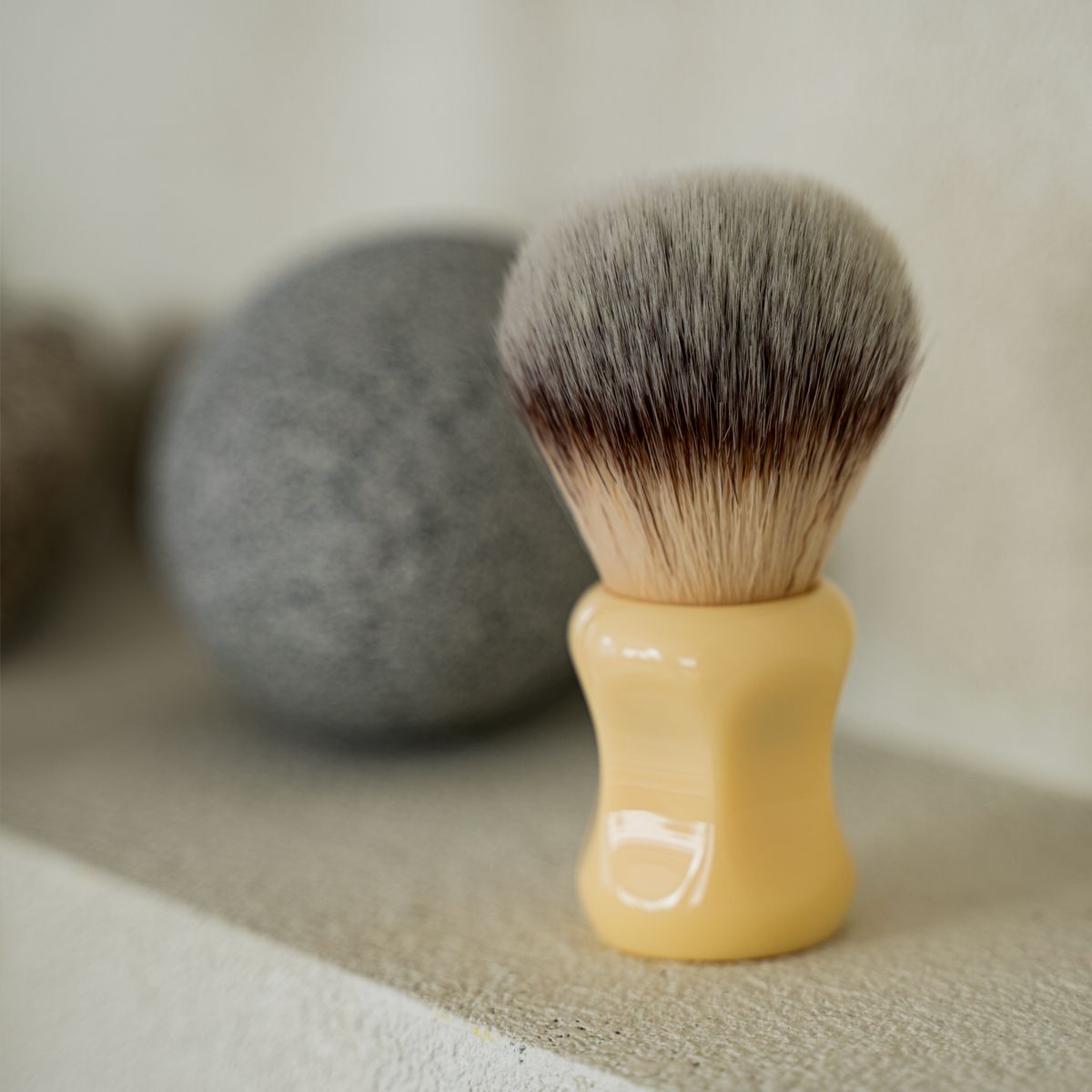 LAZY SOCIETY Classic Shaving Brush en gros plan, brosse à barbe sur serviette grise, marque LAZY SOCIETY, salle de bain