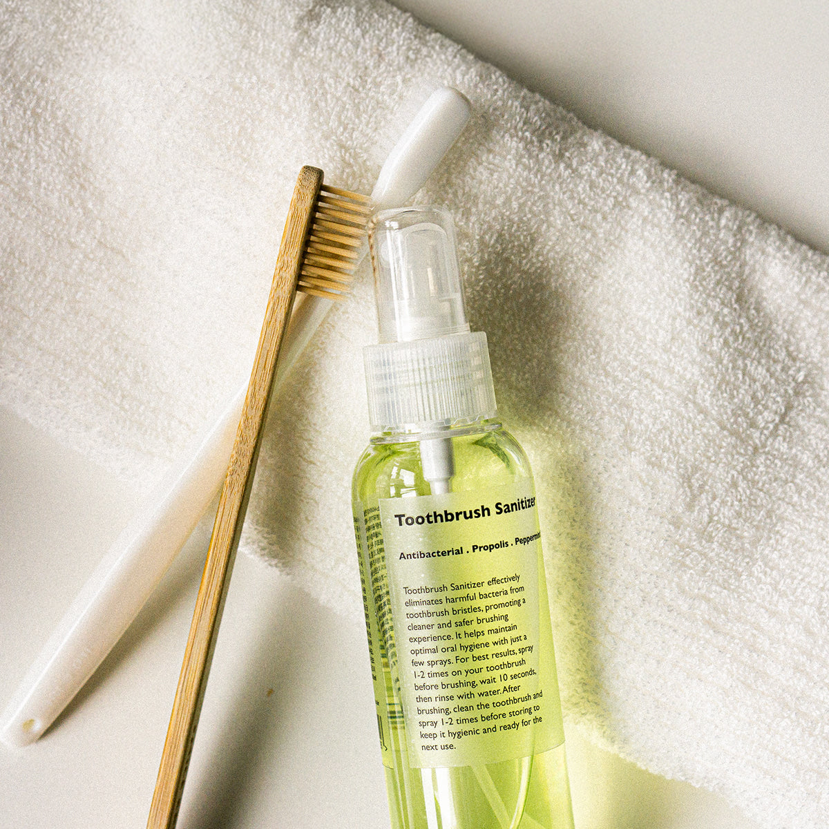 LAZY SOCIETY Toothbrush Sanitizer 100ml, flacon sur serviette, brosse à dents, contexte hygiène à la maison
