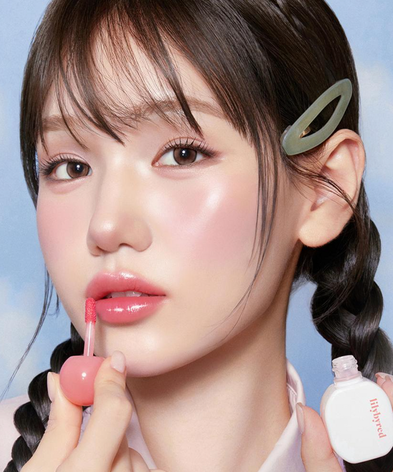 Femme appliquant LILIBYRED Sugar Wrapping Tint Gloss pour un effet lumineux et naturel.