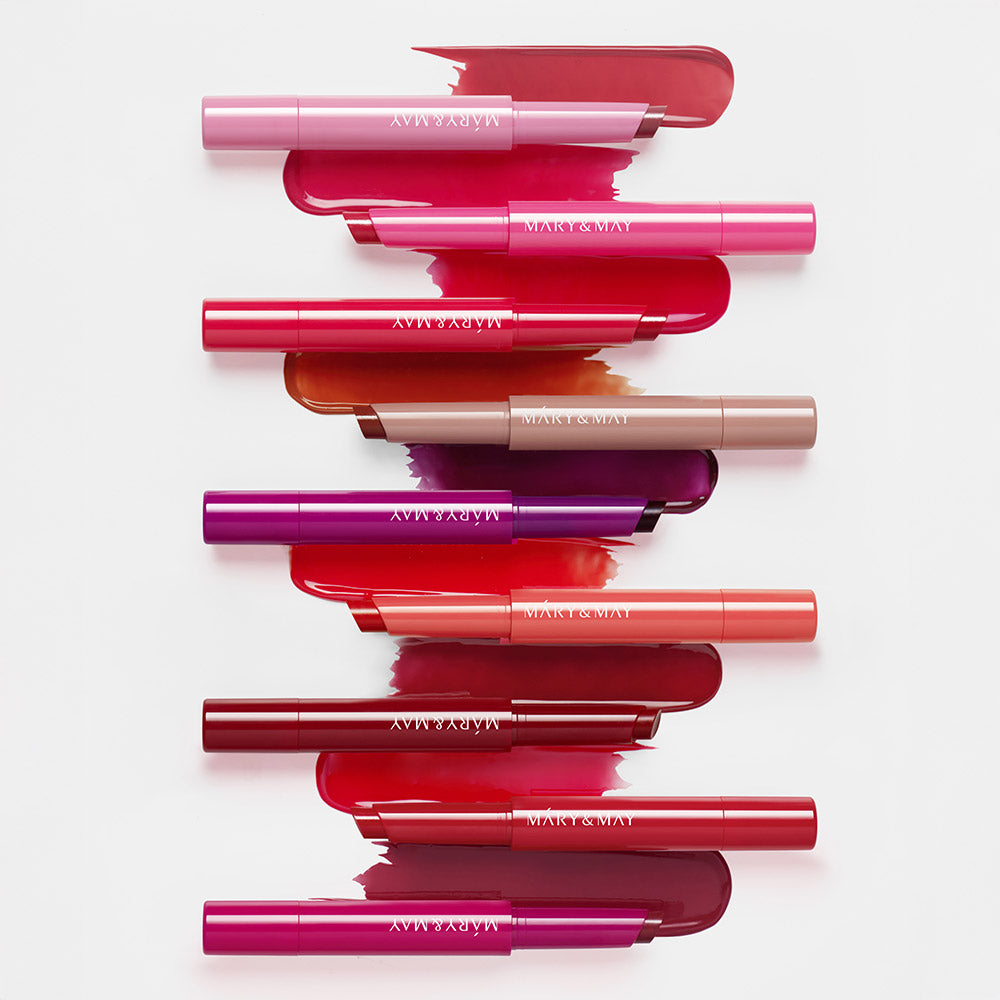 Décris l'image en français : MARY&MAY Blooming Glow Lip 09 Sunset Tangerine 1.7g, baumes colorés sur fond clair.