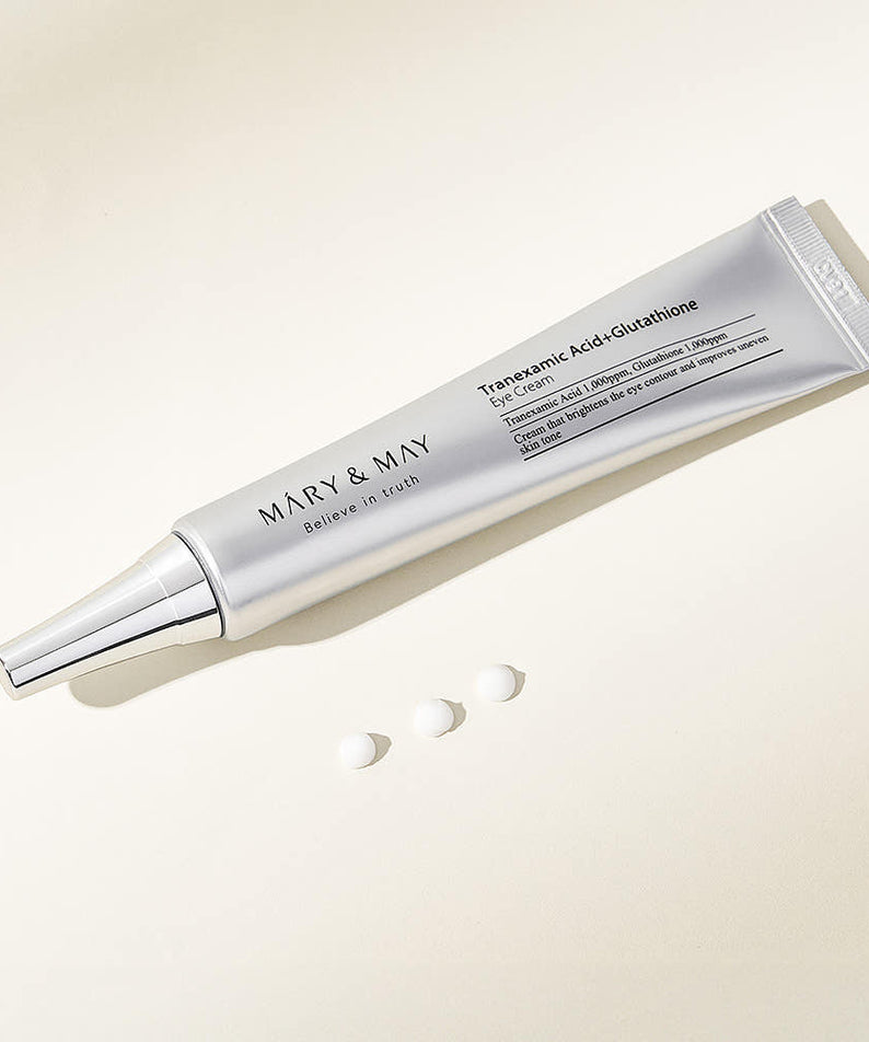 Tube de MARY&MAY Tranexamic Acid Glutathione Eye Cream 30ml, crème raffermissante pour les yeux sur fond clair.