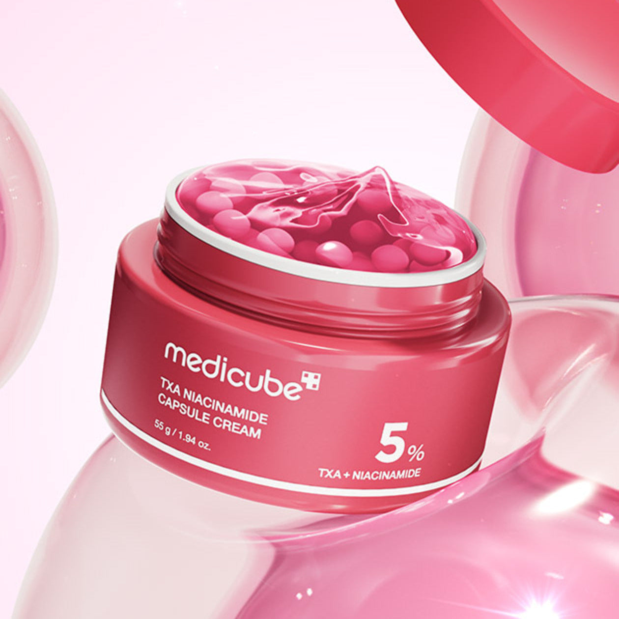 MEDICUBE Tranexamic Acid Freckle Toning Capsule Cream Mediacube crème tonique pour taches, pot rouge sur fond rose visuel