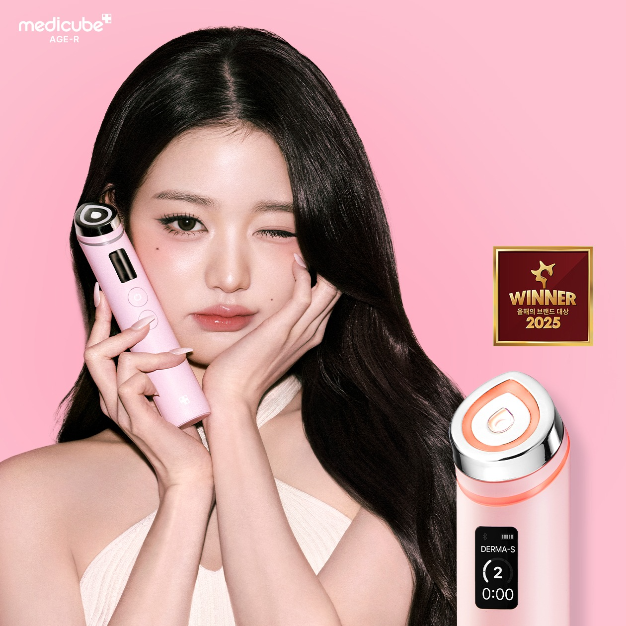 Décris l'image en français : MEDICUBE AGE R Booster Pro PINK Edition, jeune femme utilisant l’appareil rose sur fond rose.