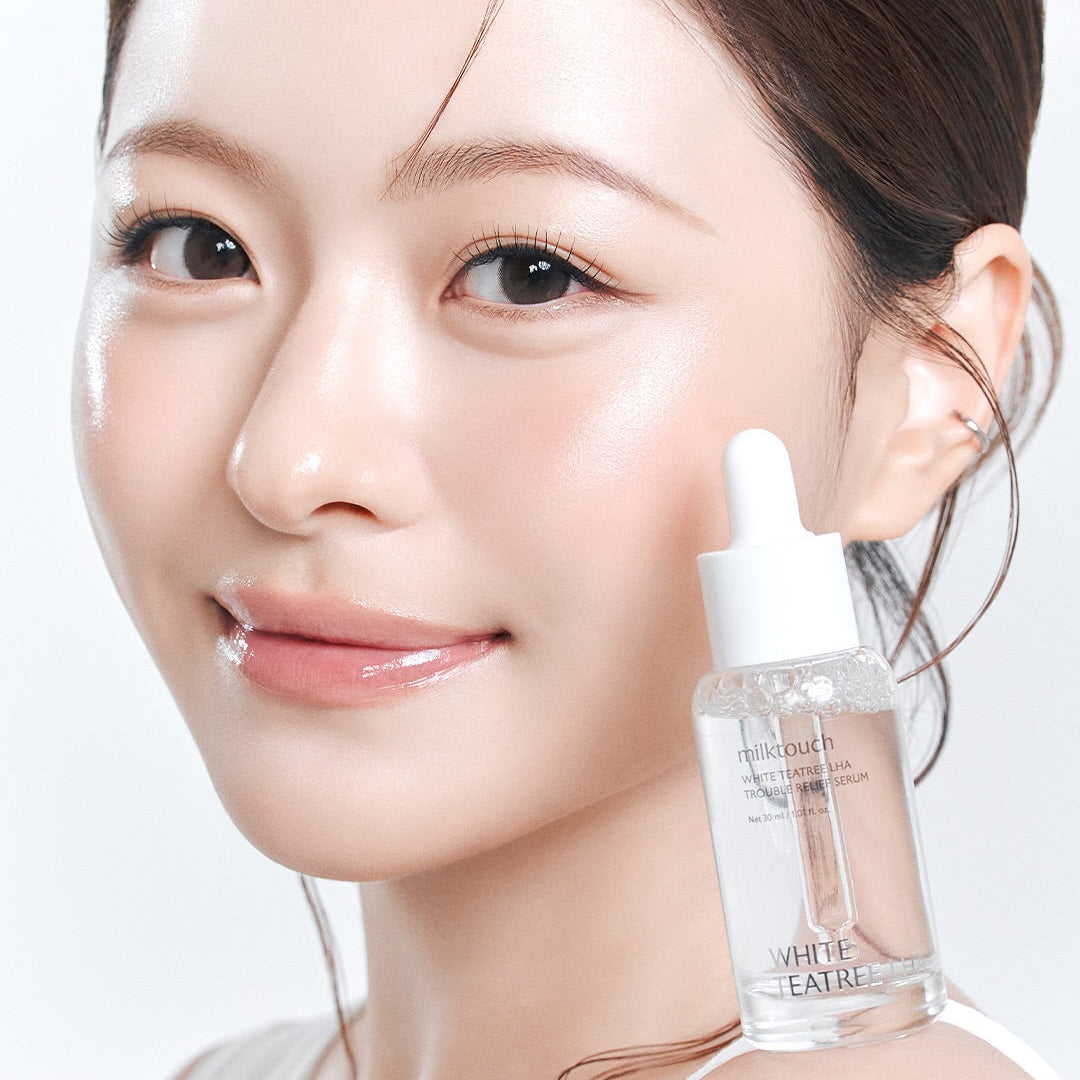 MILK TOUCH White Tea Tree Laha Trouble Relief Serum 30ml, flacon sur fond clair, peau du visage avec application, marque MILK TOUCH.
