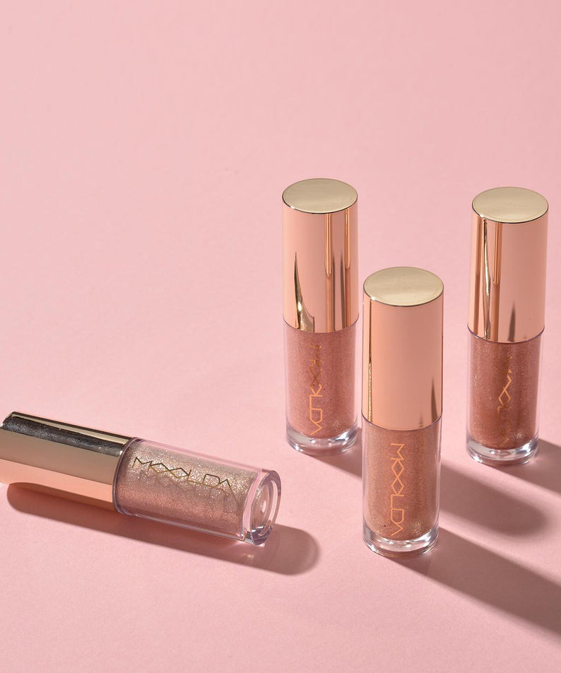 Ensemble de fards à paupières MOOLDA Bonita Glitter Shadow sur fond rose, idéal pour un maquillage éclatant.