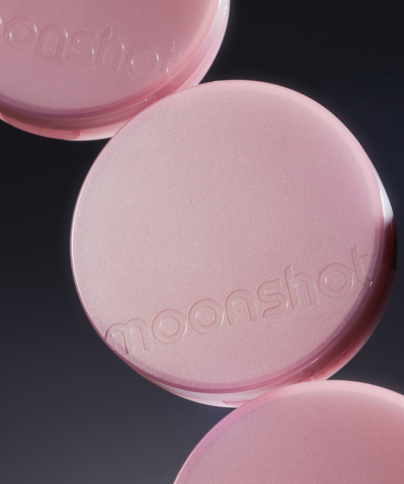 MOONSHOT Conscious Fit Cushion Foundation Pink Moon Edition en gros plan, emballage rose lumineux sur fond sombre.