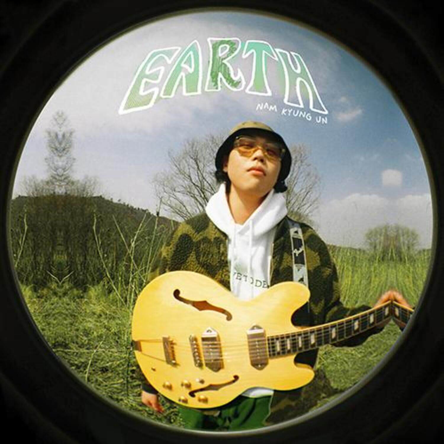 NAM KYUNG UN - [earth] - Album Kpop : NAM KYUNG UN en guitare jaune, décor nature, visuel rond, marque Nam Kyung Un.