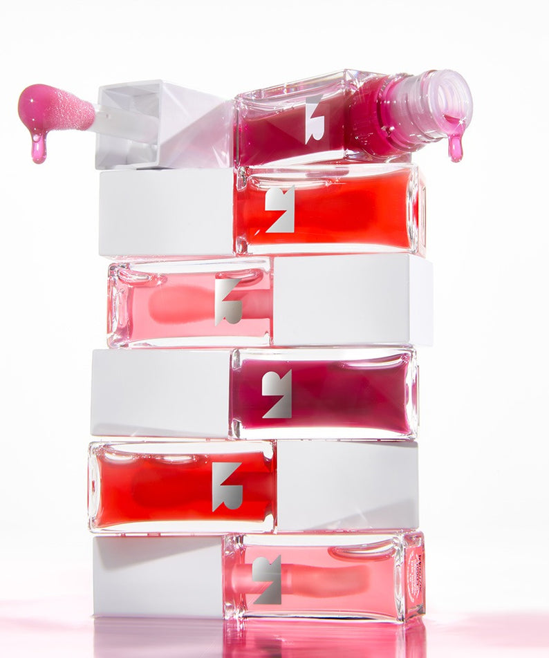 NATURE REPUBLIC Glaze Shine Lip Oil empilés, montrant des couleurs variées et un applicateur avec huile de lèvres qui coule.