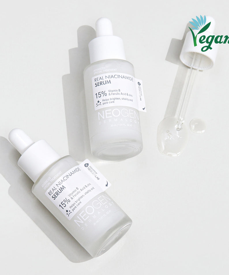 Flacons de NEOGEN Real Niacinamide 15% Serum 30ml avec pipette, soin vegan dans un emballage élégant.