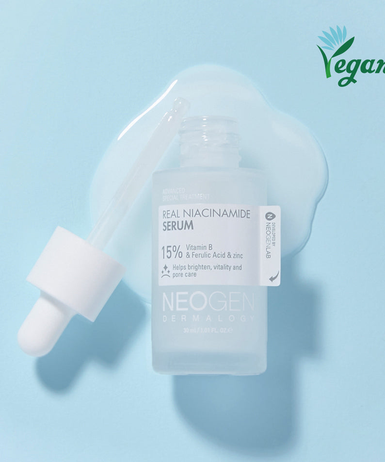 Sérum NEOGEN Real Niacinamide 15% 30ml sur fond bleu, flacon avec pipette, produit vegan pour soins de peau, transparence du liquide visible.