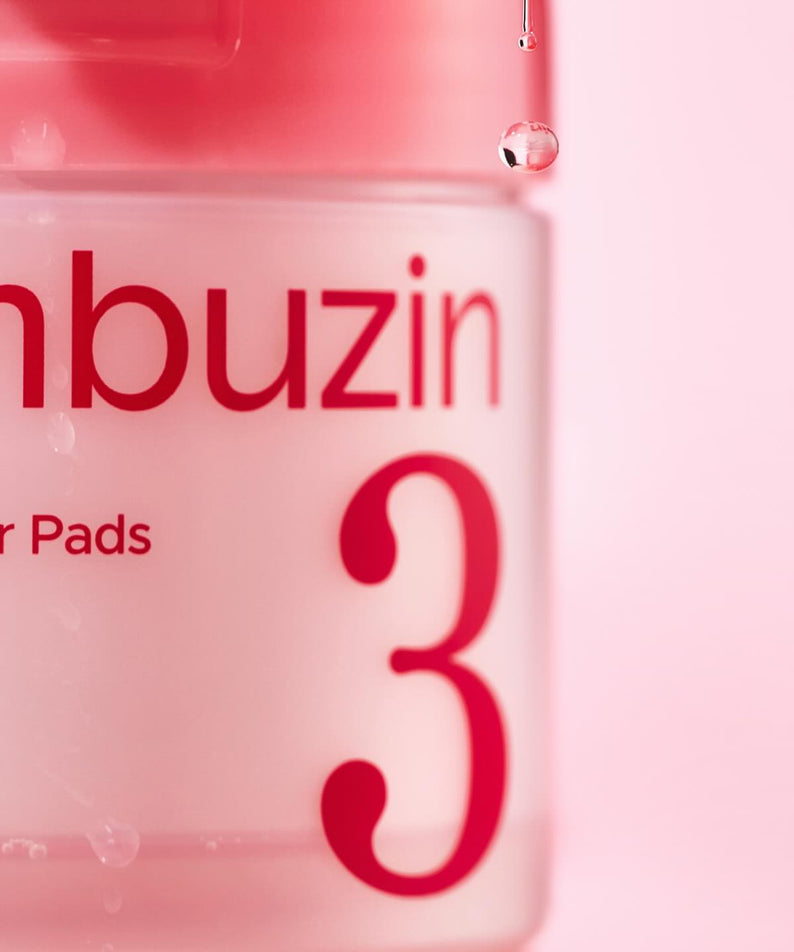 NUMBUZIN No.3 Bifida Bakuchiol Exfoliating Toner Pads, boîte rose avec logo NUMBUZIN 3, gouttes et fond pastel.