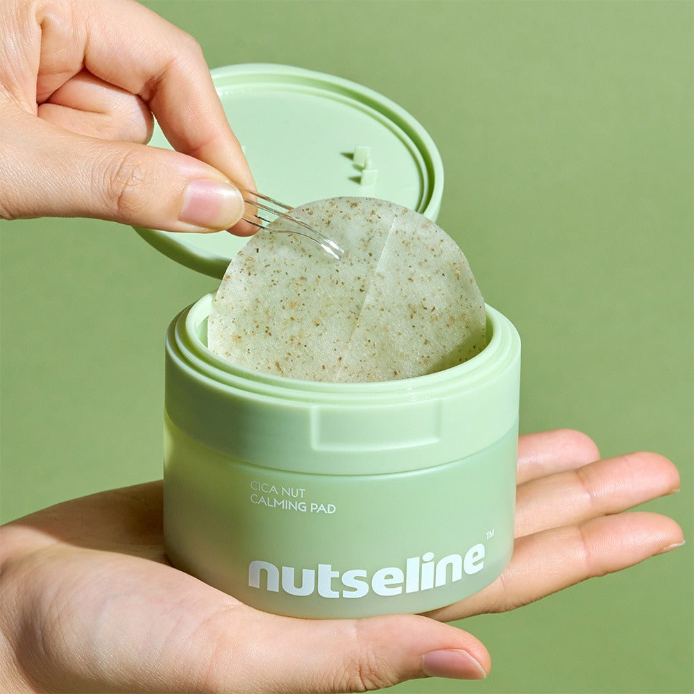 Main ouvre NUTSELINE Cica Calming Pad, coussin apaisant cica dans un pot vert sur fond vert, marque NUTSELINE