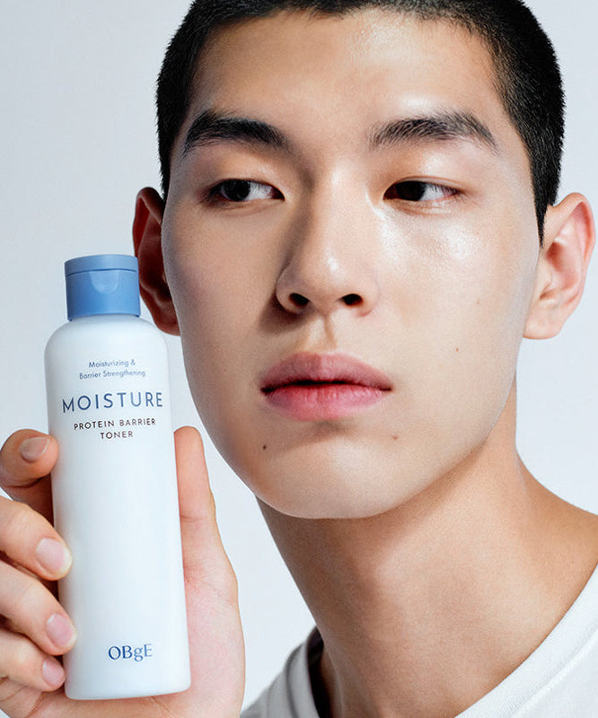 OBGE Moisture Protein Barrier Toner 200ml, flacon bleu tenu par un homme, peau hydratée, fond studio clair.