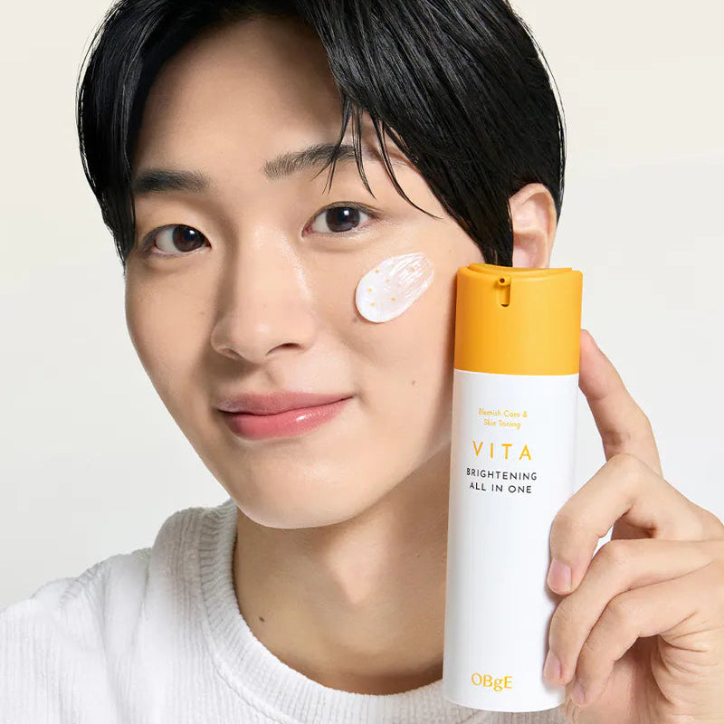 Décris l'image en français : OBGE Vita Brightening All-in-One 150ml ObGé, homme pose crème, produit sur fond clair.