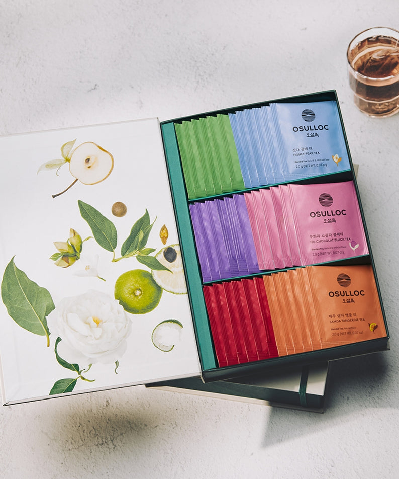 OSULLOC Tea Variation O 6 types, coffret de thés multicolores sur table avec fleurs et tasse, style photo produit.