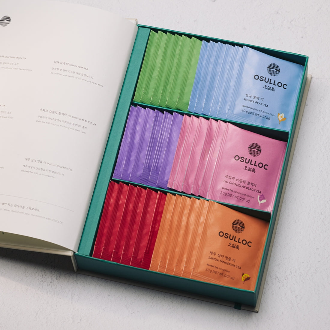 OSULLOC Tea Variation O 6 types : boîte assortie sur table, rubans de thés colorés, marque OSULLOC, ouvert.