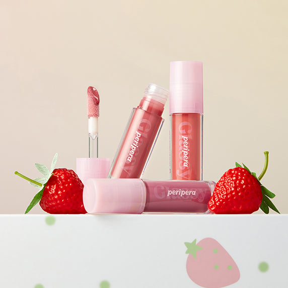 PERIPERA Ink Glazing Lip Gloss, pack et gloss rose avec fraises sur fond beige, visuel promo en français.