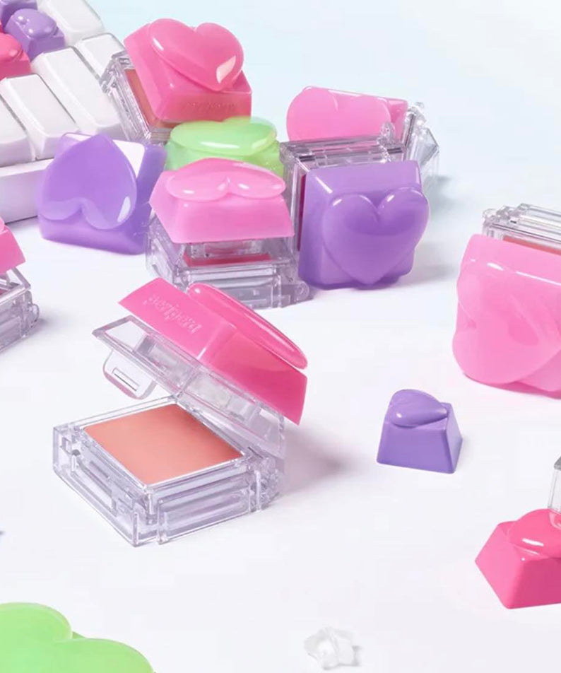 PERIPERA Talk Blush Keycap, gélules de maquillage roses et violettes sur fond blanc, pack transparent multicolore.