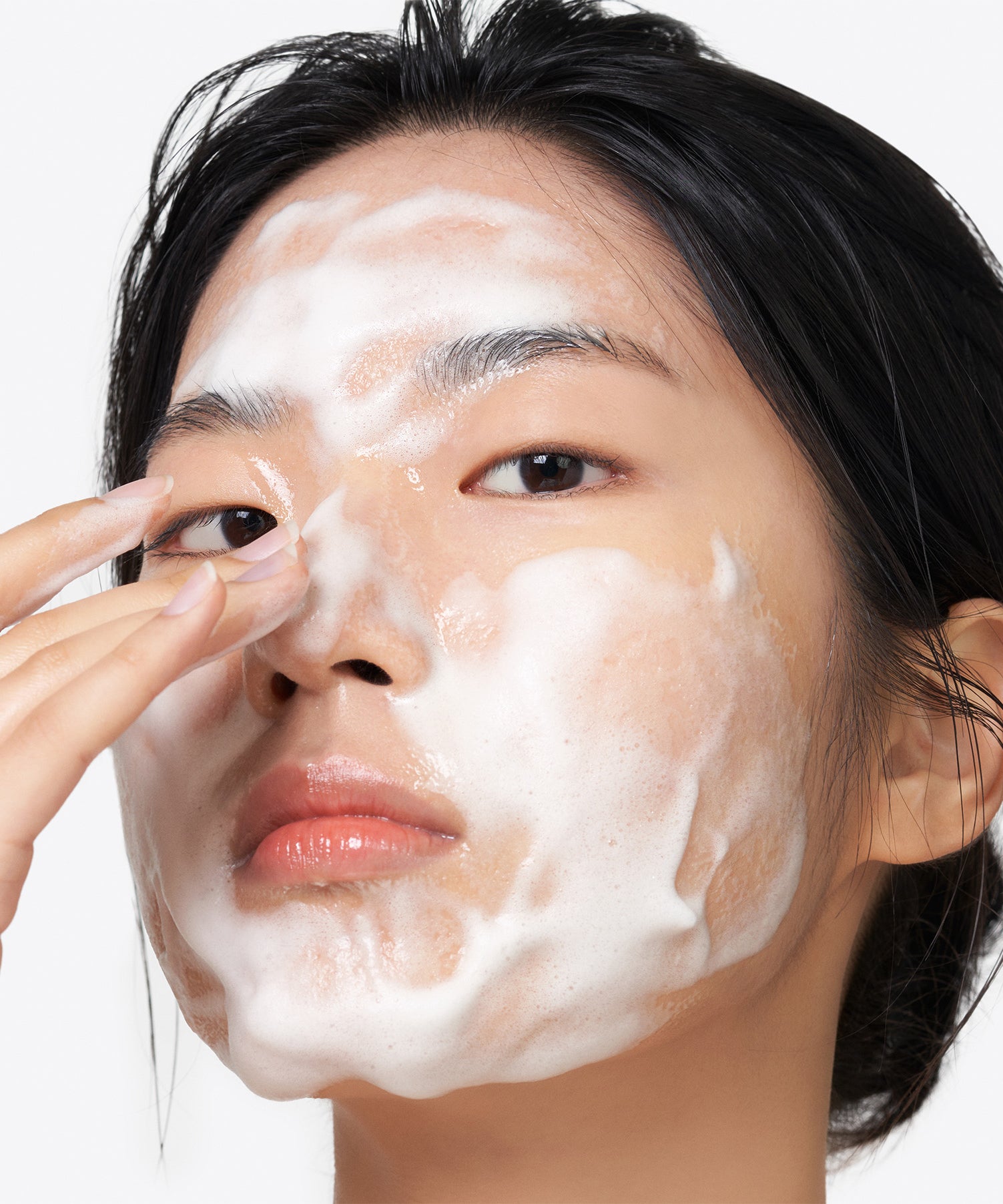 Personne appliquant la mousse du PURITO Clear Code Superfruit Cleanser 150ml, nettoyant visage PURITO sur peau.