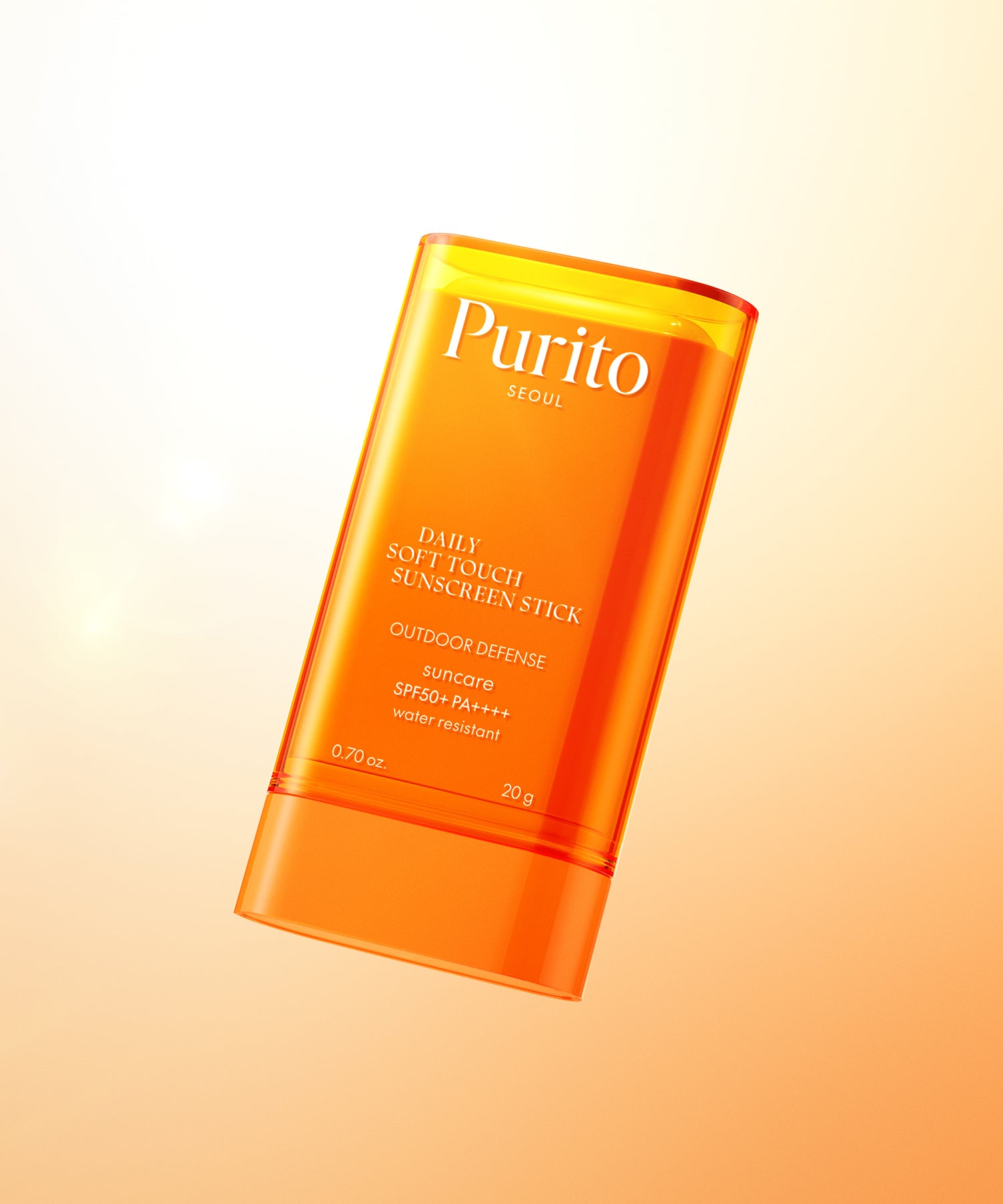 PURITO Daily Soft Touch Sun Stick SPF50+PA++++ de Purito en stick orange sur fond beige, style skincare ensoleillé.