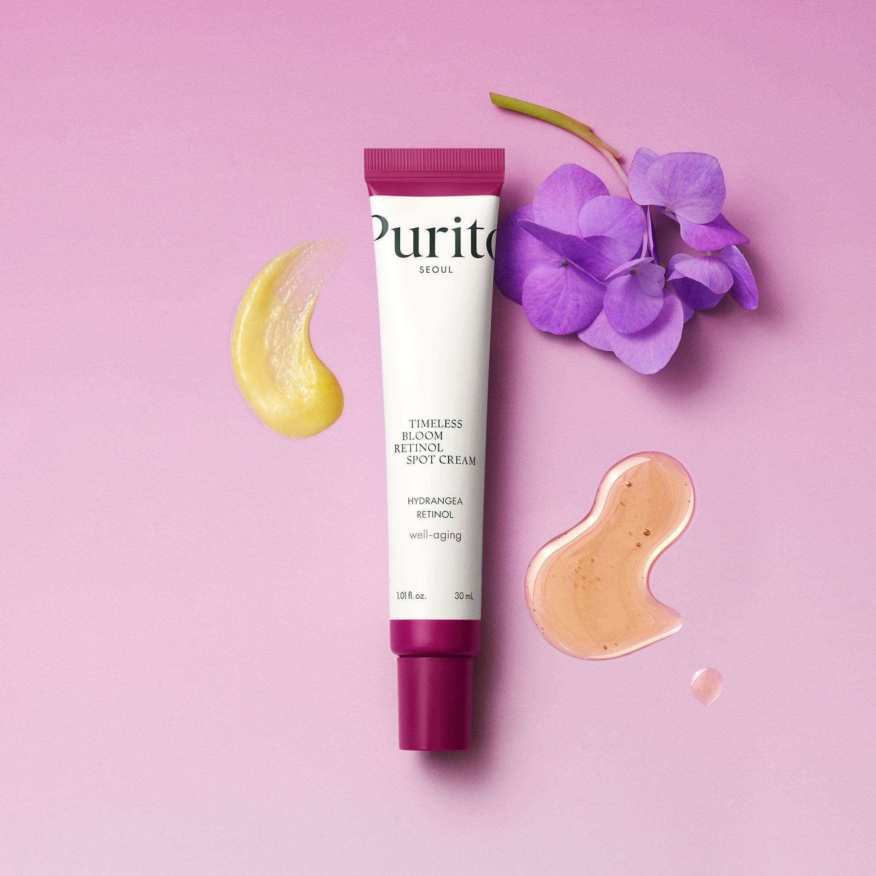 PURITO Timeless Bloom Retinol Spot Cream 30ml de Purito, sur fond rose avec fleurs et touches crème.