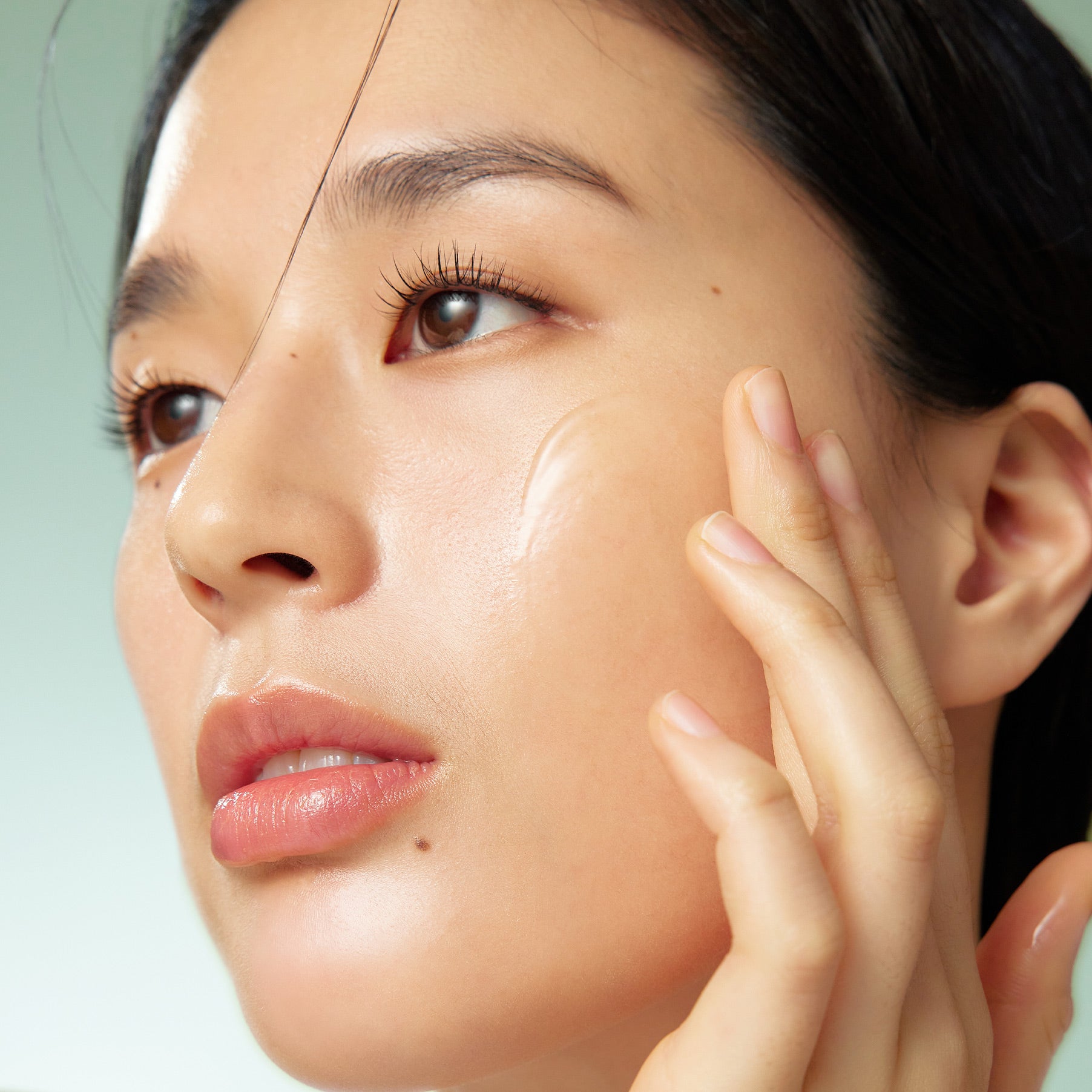 Décris l'image en français : visage avec peau hydratée, PURITO Wonder Releaf Centella Serum Unscented 60ml, marque PURITO, sérum.
