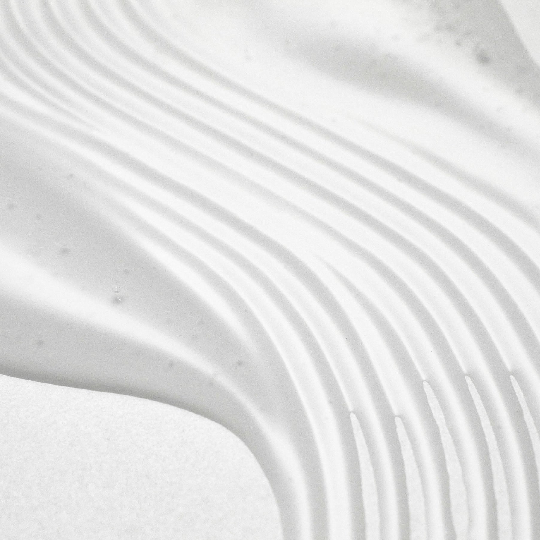 PURITO Wonder Releaf Centella Serum Unscented 60ml, flacon sur fond blanc avec texture de crème, gros plan.